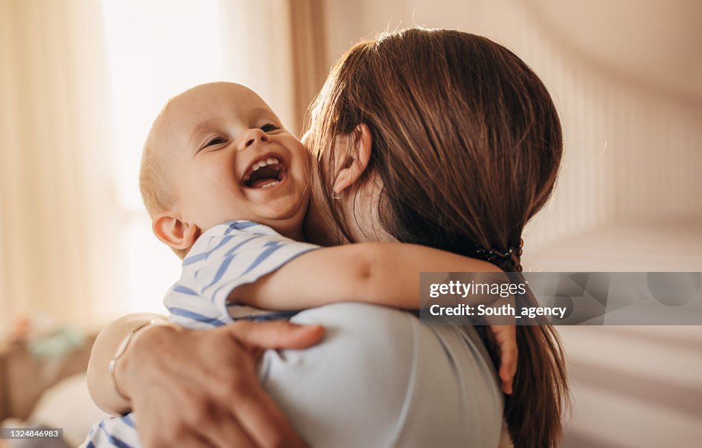 Mother hugging her little son