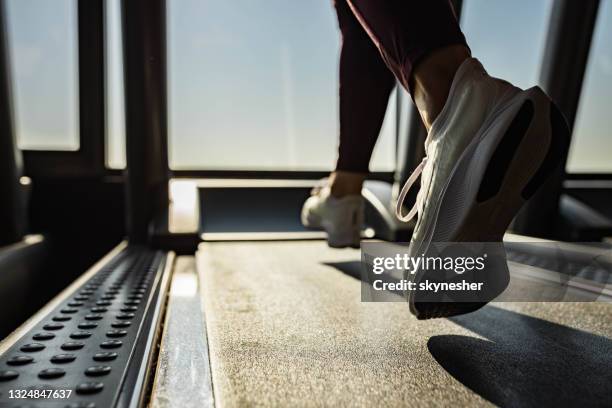 close up of unrecognizable athlete running on treadmill in a gym. - treadmill stock pictures, royalty-free photos & images