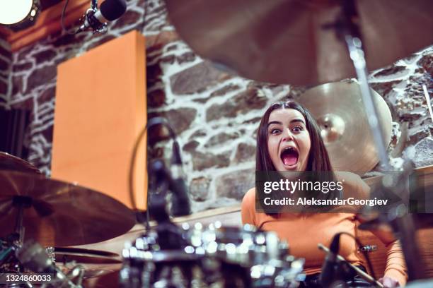 crazy female drummer excited to perform song in studio - drummer stock pictures, royalty-free photos & images