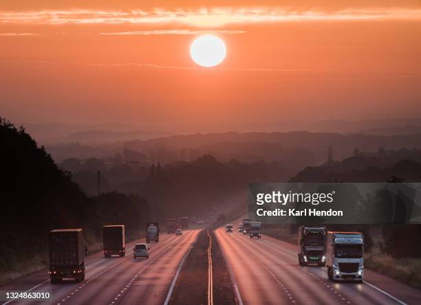 an elevated view of a uk motorway at sunrise - stock photo - brexit travel stock pictures, royalty-free photos & images