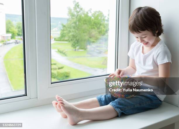 a child plays with hydrogel beads - girl and shower gel stock pictures, royalty-free photos & images