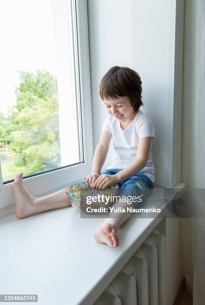 a child plays with hydrogel beads - girl and shower gel stock pictures, royalty-free photos & images