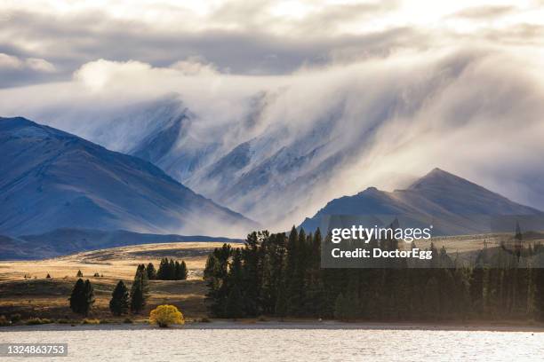 scenic landscape of mist covered on mount dobson near lake tekapo, new zealand - lake pukaki stock pictures, royalty-free photos & images