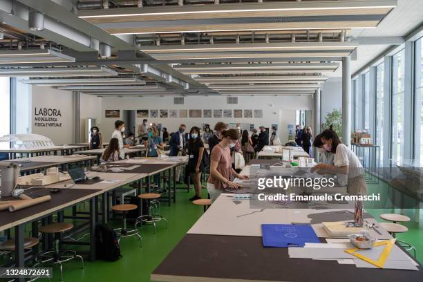 Two students work on a model of building during the opening ceremony of the new International Architecture Campus at Politecnico di Milano on June...