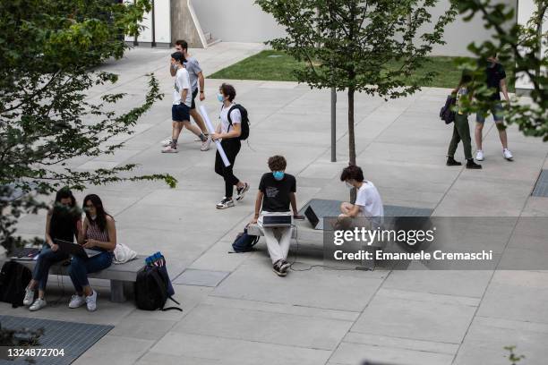 Students sit and walk during the opening ceremony of the new International Architecture Campus at Politecnico di Milano on June 22, 2021 in Milan,...