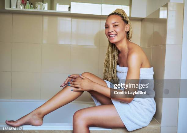 shot of a young woman moisturising her legs after shaving it - wax strip stock pictures, royalty-free photos & images