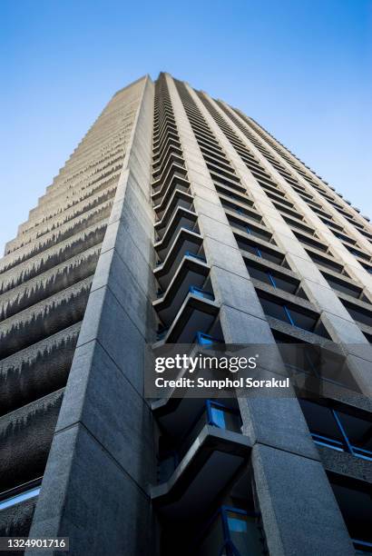 view looking up along the concrete structure of shakespeare tower in barbican estate, london uk - london 1970s stock pictures, royalty-free photos & images