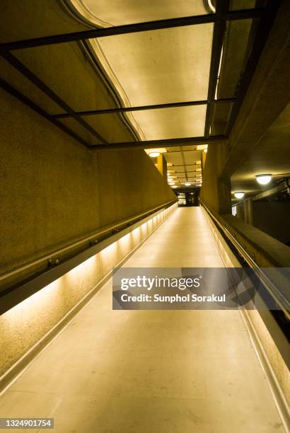 a ramp with mirror ceiling inside the barbican centre, london uk - barbican stock pictures, royalty-free photos & images