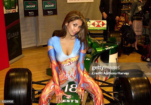 British model Leilani poses for photographers on a Jaguar Formula 1 race car July 11, 2001 at Hamleys toy store in London, England during the launch...