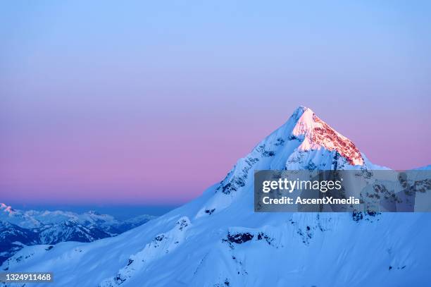 scenic view of mountain peak at sunrise - snowcapped mountain stock pictures, royalty-free photos & images