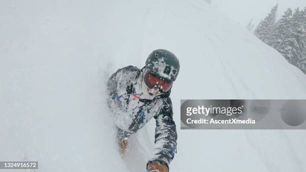 skier descends snow slope through deep powder snow - extreme skiing stock pictures, royalty-free photos & images
