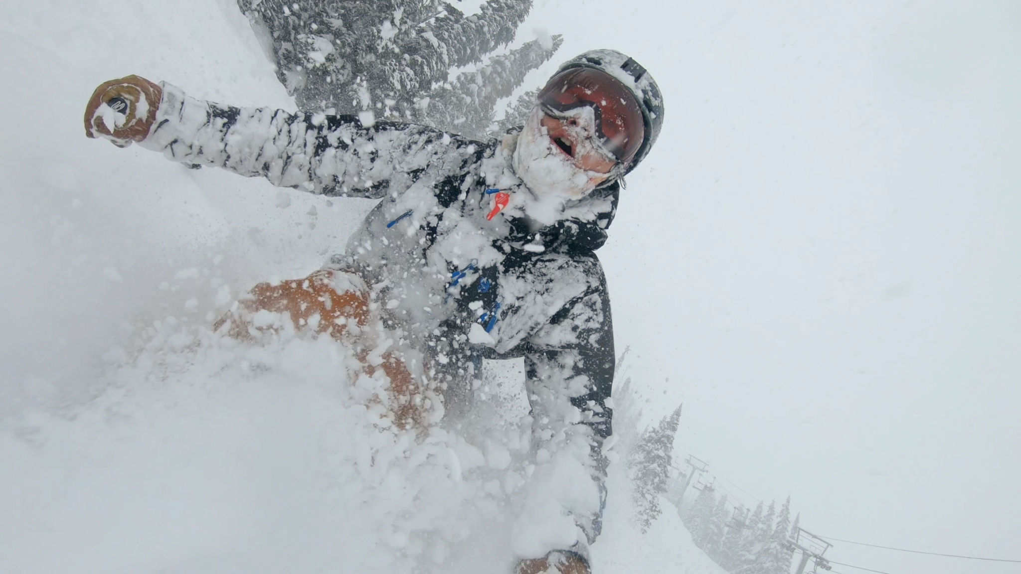 Skier descends snow slope through deep powder snow Skier descends snow slope through deep powder snow