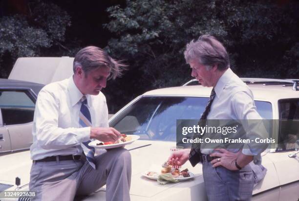 Jimmy Carter and Walter Mondale having a snack and a conversation, on a car in his hometown of Plains, Georgia, during their campaign for President...