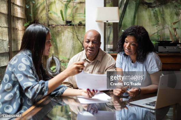 real estate agent or finance advisor doing a meeting with customers at home - lawyer explaining stock pictures, royalty-free photos & images