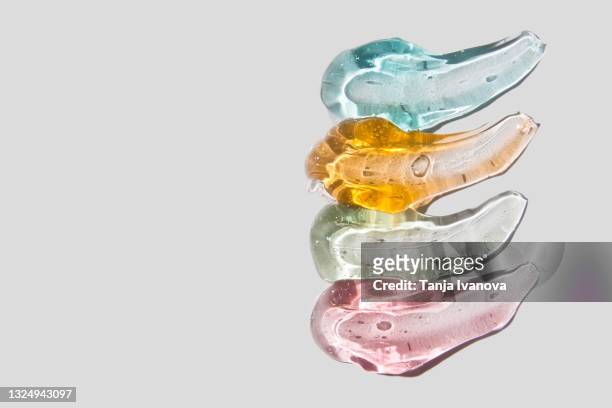 transparent smears of colorful gel on white background. flat lay, top view, copy space - amino acid foto e immagini stock