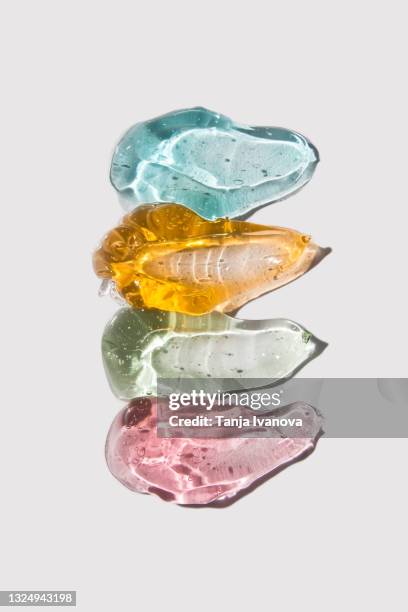 transparent smears of colorful gel on white background. flat lay, top view - schiuma da doccia foto e immagini stock