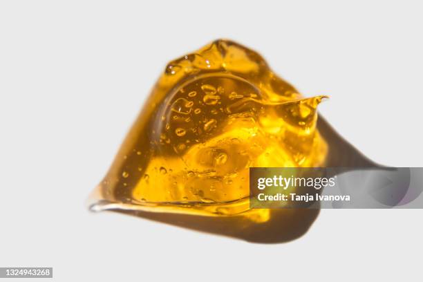 transparent drop of orange gel on white background. liquid yellow wax or sugar paste for depilation. the concept of depilation, waxing, sugaring smooth skin without hair, banner - honey face mask stock pictures, royalty-free photos & images