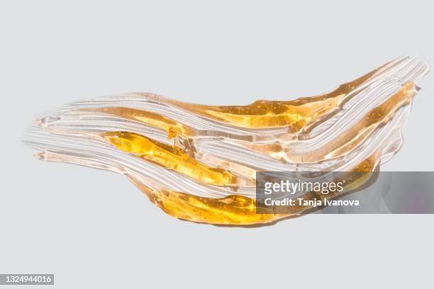 transparent smear of orange gel on white background. liquid yellow wax or sugar paste for depilation. the concept of depilation, waxing, sugaring smooth skin without hair, banner - honey face mask stock pictures, royalty-free photos & images