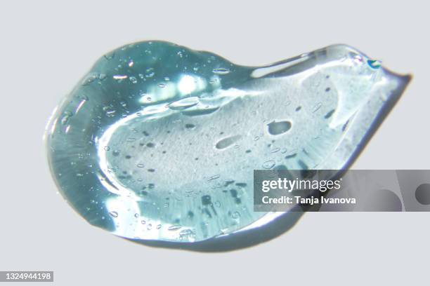 transparent smear of blue gel on white background. liquid hyaluronic acid gel. flat lay, top view, copy space - duschgel nobody stock-fotos und bilder