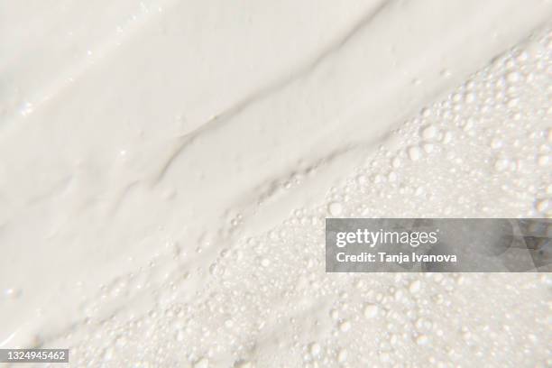 liquid textured white facial foam creamy bubble soap background. - texture mousse stock pictures, royalty-free photos & images