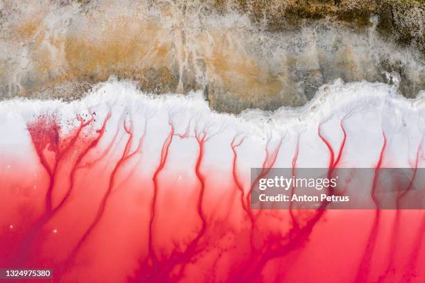 aerial view of patterns of salty pink lake. pink salt lake hutt lagoon - mining from above stock pictures, royalty-free photos & images