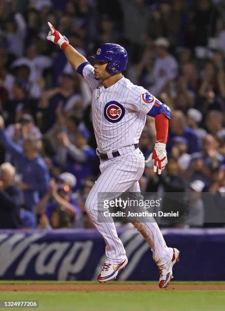 Willson Contreras of the Chicago Cubs celebrates as he runs the bases after hitting a solo home run in the 8th inning against the Cleveland Indians...