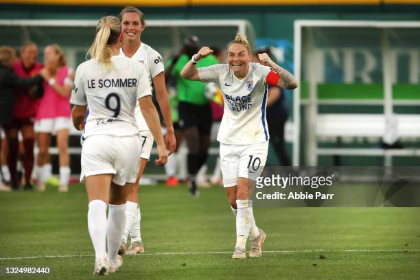 Jess Fishlock celebrates alongside Eugenie Le Sommer of OL Reign after defeating the Chicago Red Stars 2-0 at Cheney Stadium on June 22, 2021 in...