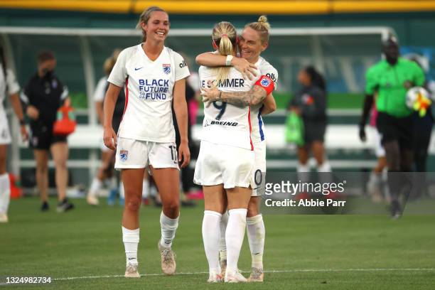 Jess Fishlock and Eugenie Le Sommer of OL Reign hug after defeating the Chicago Red Stars 2-0 at Cheney Stadium on June 22, 2021 in Tacoma,...