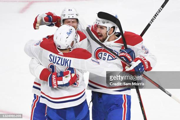 Nick Suzuki of the Montreal Canadiens celebrates with Eric Staal, and Jake Allen after Staal's goal against the Vegas Golden Knights during the...