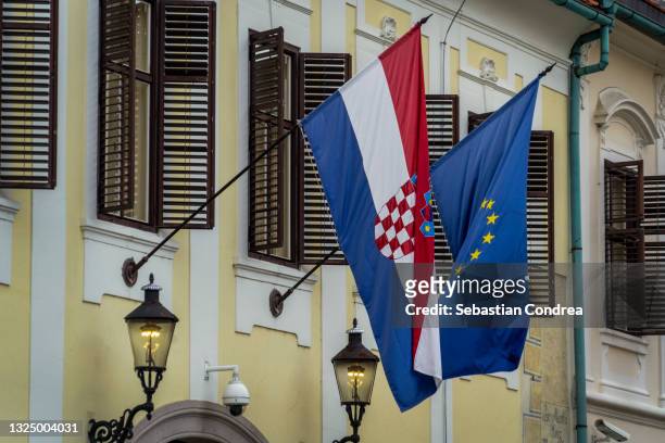 two flags, croatian and european union at the consulate. - croatian flag stock-fotos und bilder