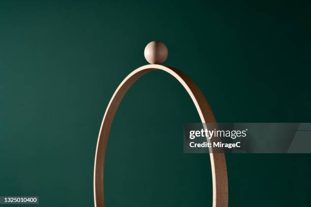 a wooden sphere on top of wood ring - china balance stock pictures, royalty-free photos & images