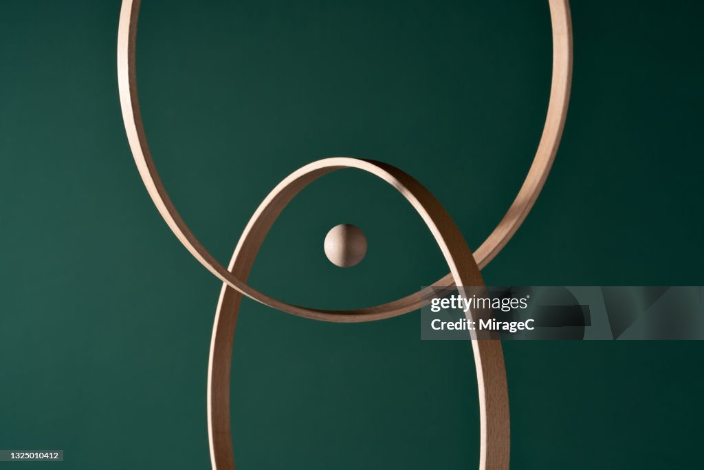 A Wooden Sphere in the Center of Intersected Rings