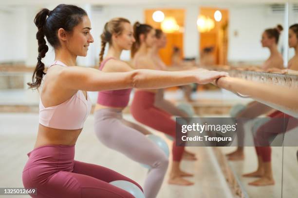 barre fit exercise class. group of people in a row at a barre workout class - barre class bildbanksfoton och bilder