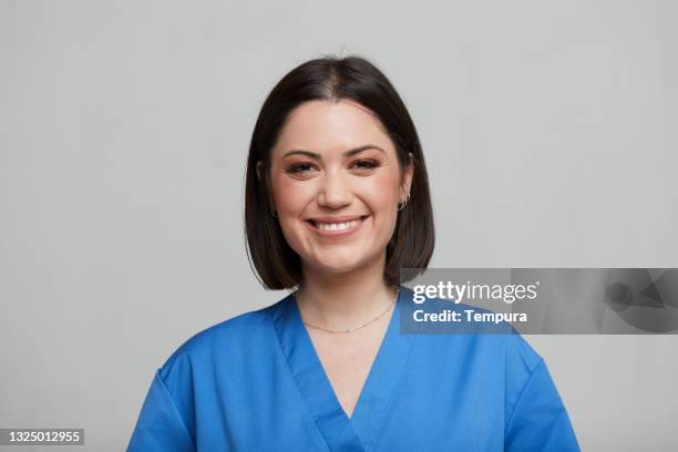 headshot portrait of a young nurse. - nurse headshot stock pictures, royalty-free photos & images