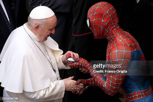 Pope Francis receives a Spiderman mask as a gift from Mattia Villardita, a young man in the Spider-Man costume who makes children smile in the...