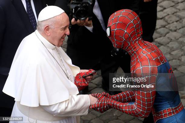 Pope Francis greets Mattia Villardita, a young man in the Spider-Man costume who makes children smile in the pediatric wards of hospitals, during his...