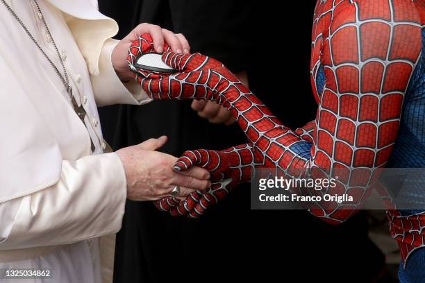 Pope Francis receives a Spiderman mask as a gift from Mattia Villardita, a young man in the Spider-Man costume who makes children smile in the...
