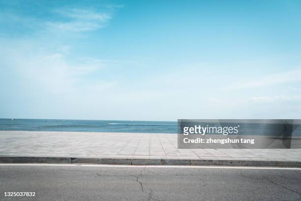 highway by the sea. - cloud sky stock pictures, royalty-free photos & images