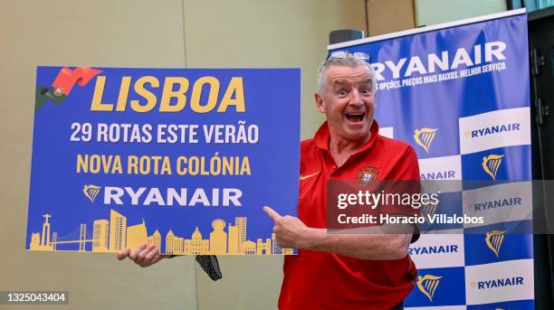 Ryanair Group CEO Michael O'Leary wears a Portuguese national Soccer team jersey while holding a Ryanair advertisement at his press conference in Lux...