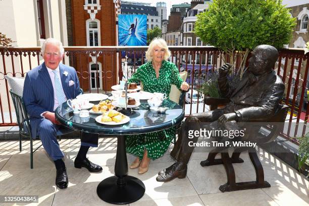 Prince Charles, Prince of Wales and Camilla, Duchess of Cornwall enjoy afternoon tea on the terrace beside a life-sized statue of famed playwright,...