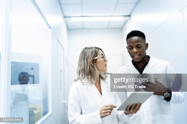 colleagues using digital tablet in laboratory - laboratory 個照片及圖片檔