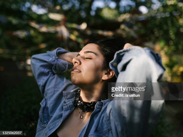 relaxed woman at beer garden - biergarten stock-fotos und bilder