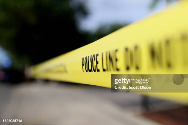 Police tape surrounds a crime scene where three people were shot at the Wentworth Gardens housing complex in the Bridgeport neighborhood on June 23,...