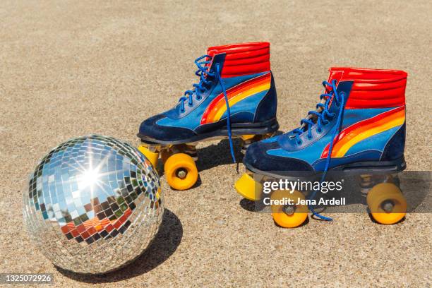1970s roller skates and disco ball - rolschaatsen schaats stockfoto's en -beelden
