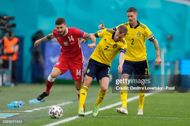 Mateusz Klich of Poland battles for possession with Sebastian Larsson of Sweden during the UEFA Euro 2020 Championship Group E match between Sweden...