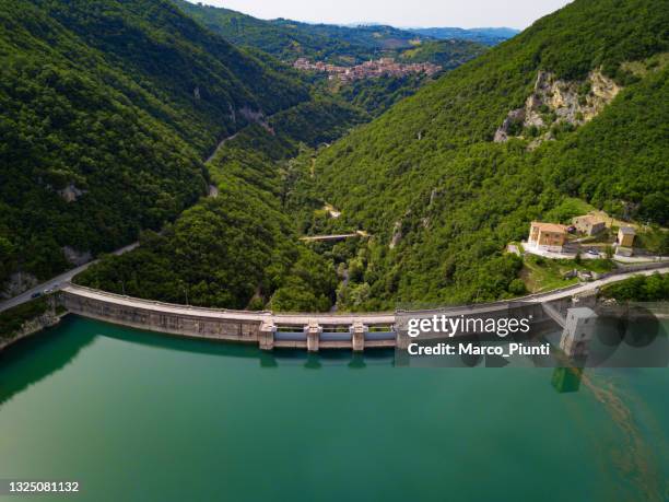 aerial view of bridge on large dam in italian apennines - hydropower dam stock pictures, royalty-free photos & images