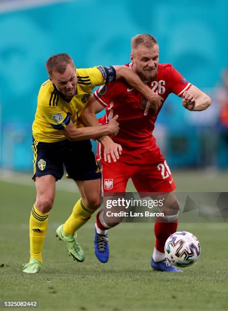 Sebastian Larsson of Sweden and Tymoteusz Puchacz of Poland battle for possession during the UEFA Euro 2020 Championship Group E match between Sweden...