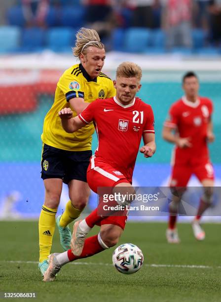 Kamil Jozwiak of Poland is challenged by Emil Forsberg of Sweden during the UEFA Euro 2020 Championship Group E match between Sweden and Poland at...
