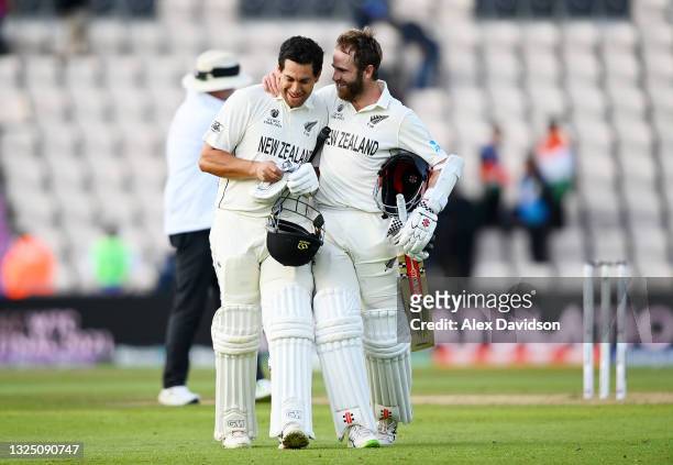 Kane Williamson and Ross Taylor of New Zealand celebrate victory as they walk off on the Reserve Day of the ICC World Test Championship Final between...