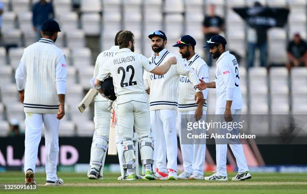 Kane Williamson of New Zealand interacts with Virat Kohli of India after victory in the Reserve Day of the ICC World Test Championship Final between...